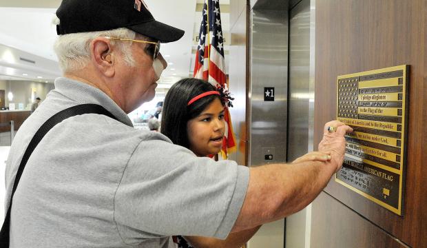 Image Blind Vet Reading Braille Embossed on Braille Flag