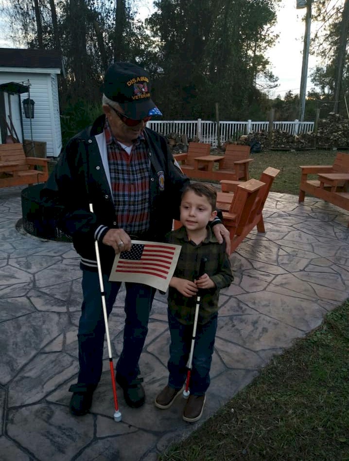 Blind 5 year old touches Braille Flag